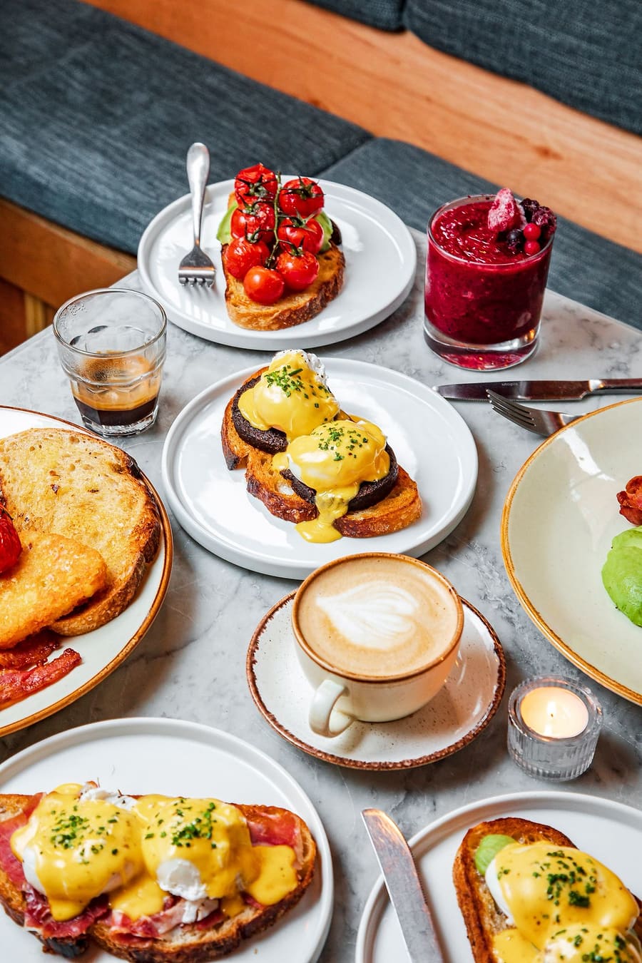 A breakfast table at Ten Streets Social - Eggs Benedict, avocado toast and flat whites from above