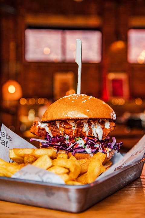 Buffalo chicken burger with slaw and house fries at Ten Streets Social