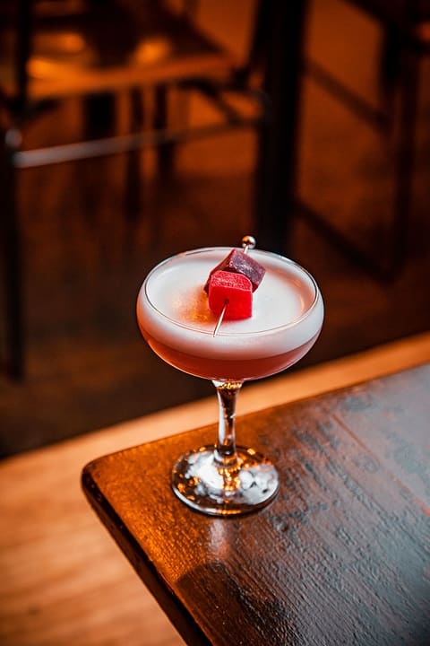 A pink cocktail with a garnish pick at the Ten Streets Social bar