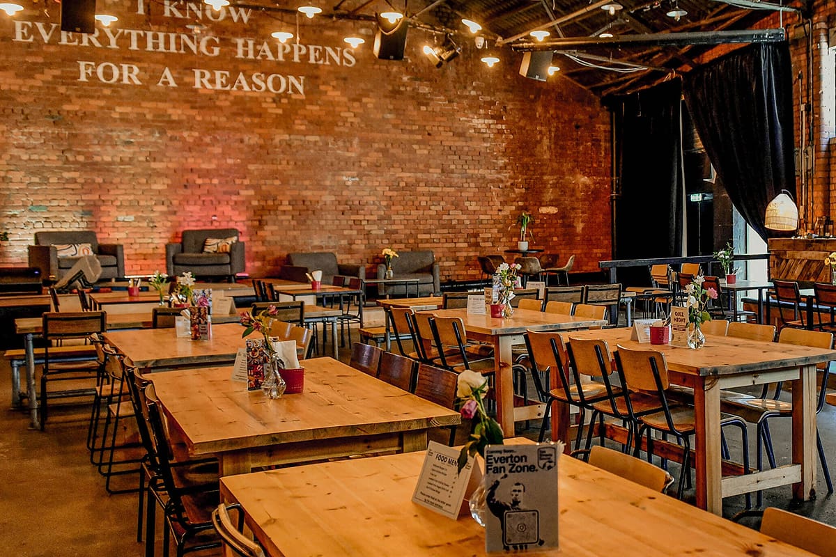The main hall at Ten Streets Social set with long timber tables, ready for an event