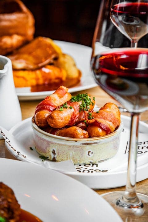 Pigs in blankets beside a roast dinner
