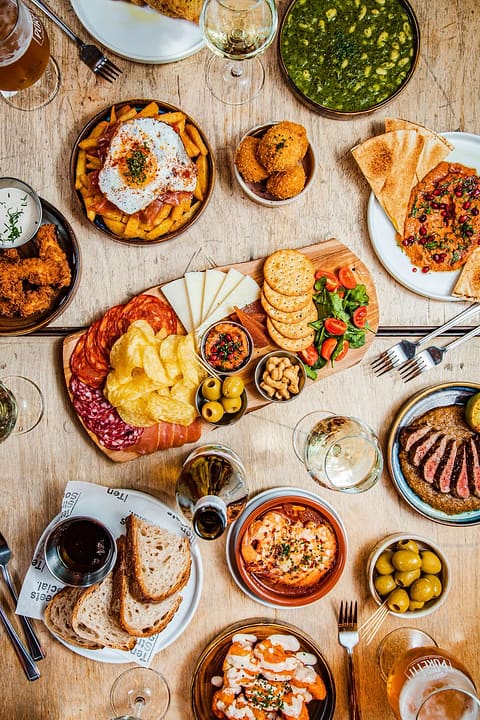 Sharing plates and flatbreads across a table at Ten Streets Social