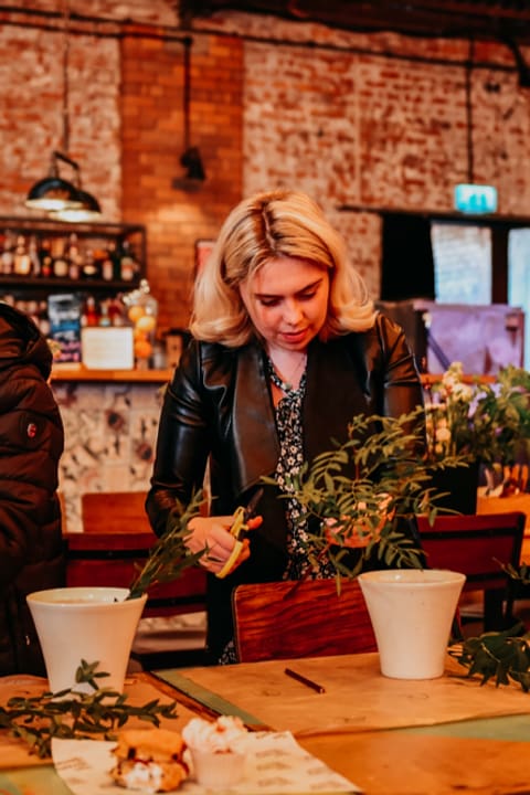 Guests making wreaths at a workshop